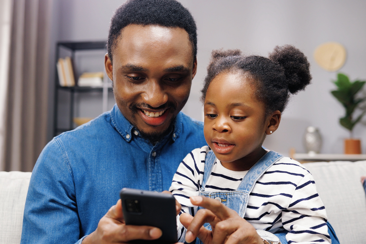 Dad and daughter looking at phone
